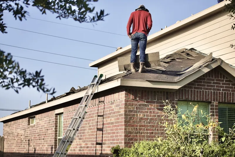 Professional roofer working on a residential roof in Blue Bell Farms